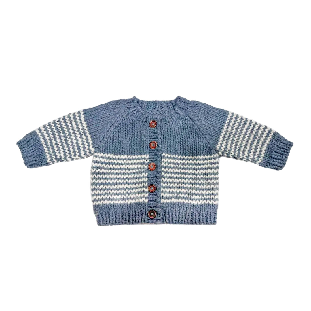 Knitted cardigan with blue and white pattern on a light gray background