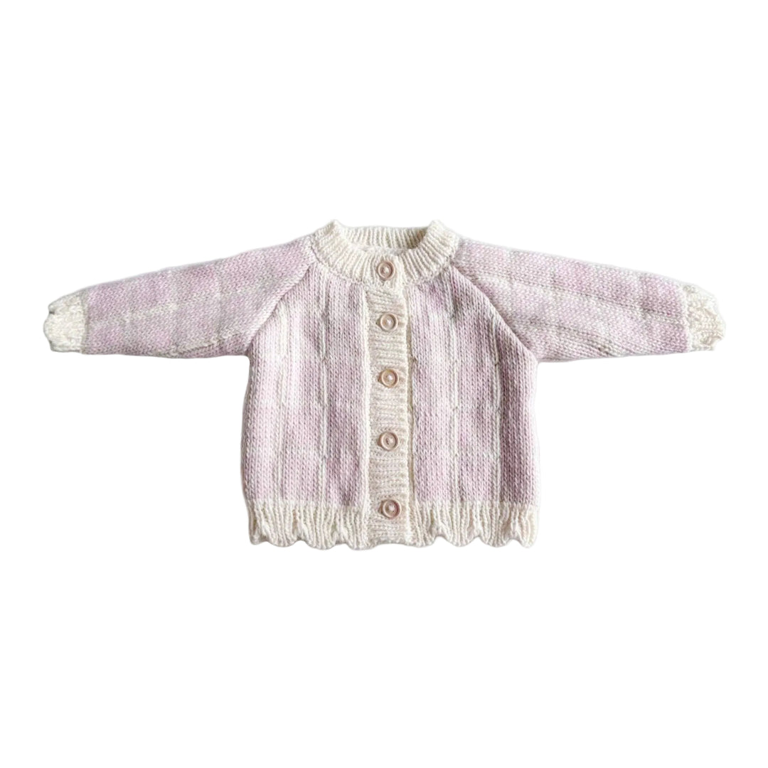 Knitted baby cardigan on a white background