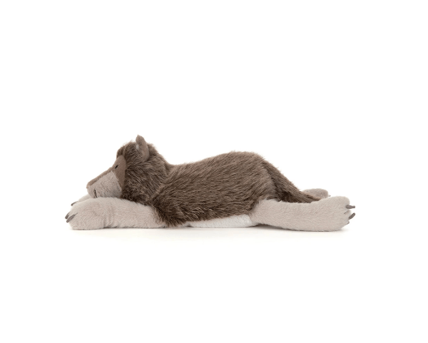 A plush stuffed animal shaped like a sleeping wolf or coyote, lying on its side with long gray paws extended, photographed on a clean white background.