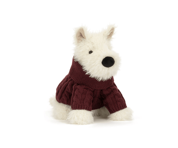 A plush West Highland terrier dog toy wearing a burgundy cable-knit sweater, photographed against a seamless white background.